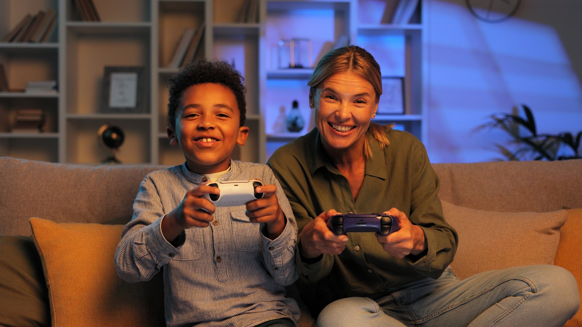 Relatives enjoy spending time together, playing races on gamepads