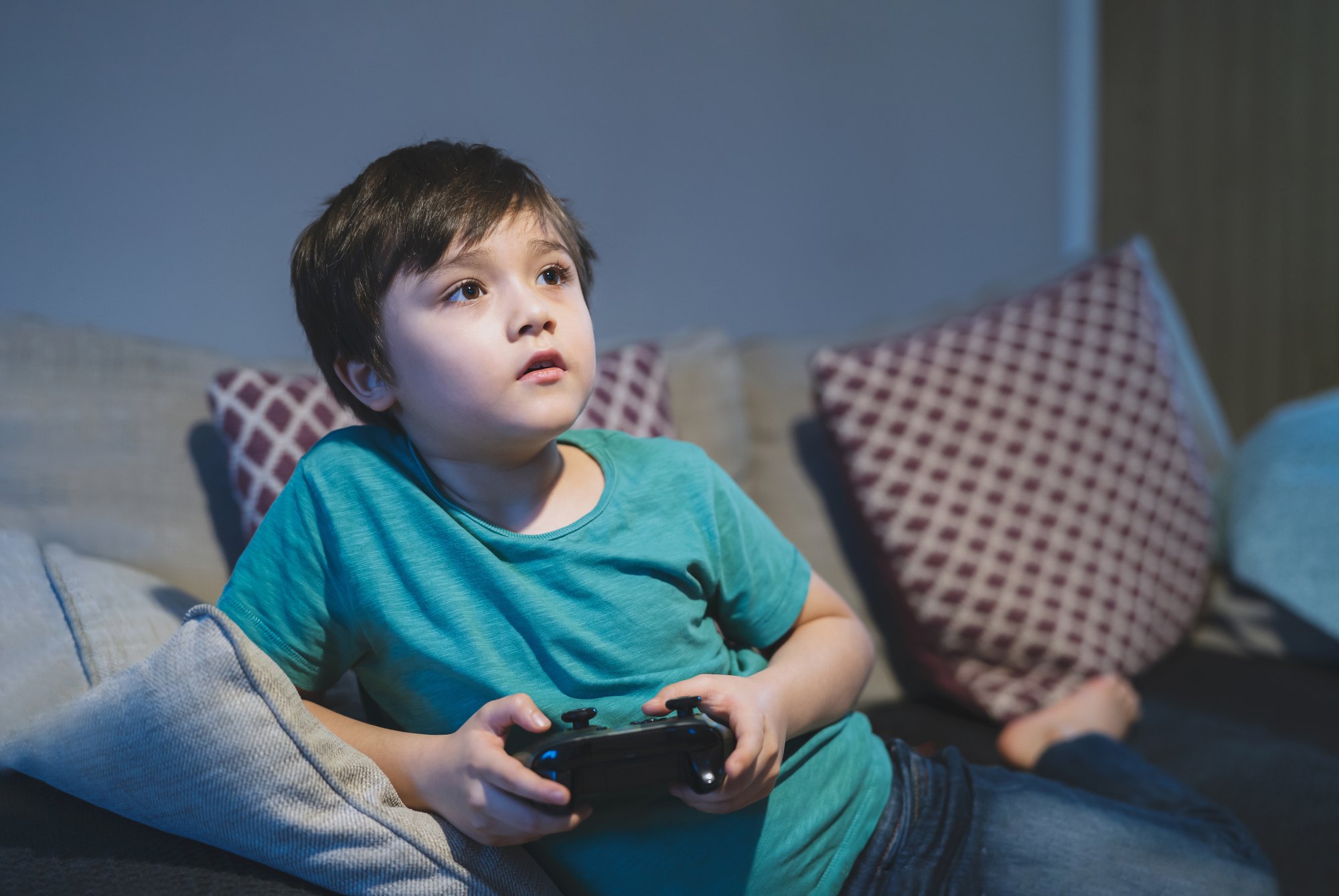 Portrait of happy kid holding a video game control